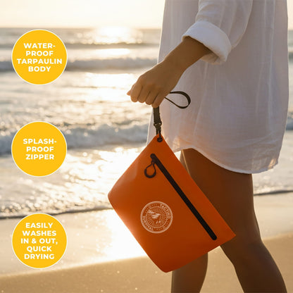 Orange waterproof pouch at beach